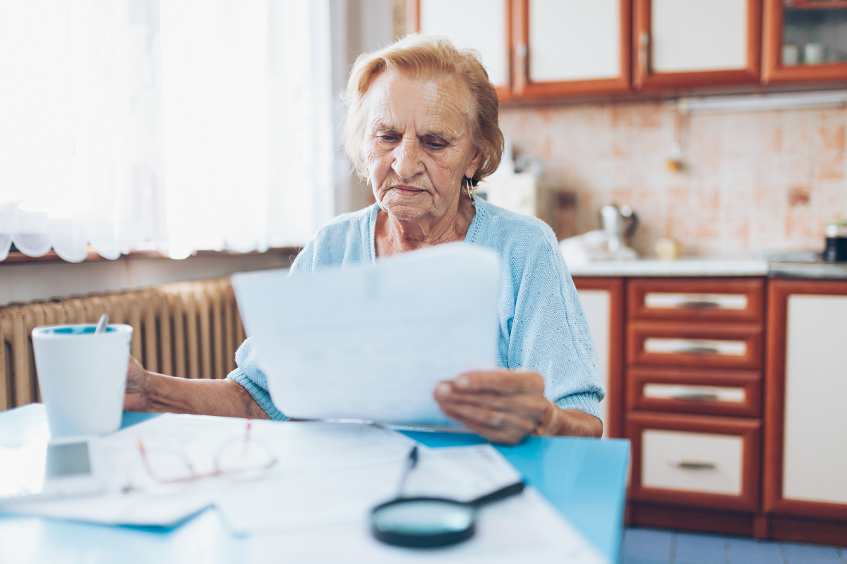 senior paying bills at home