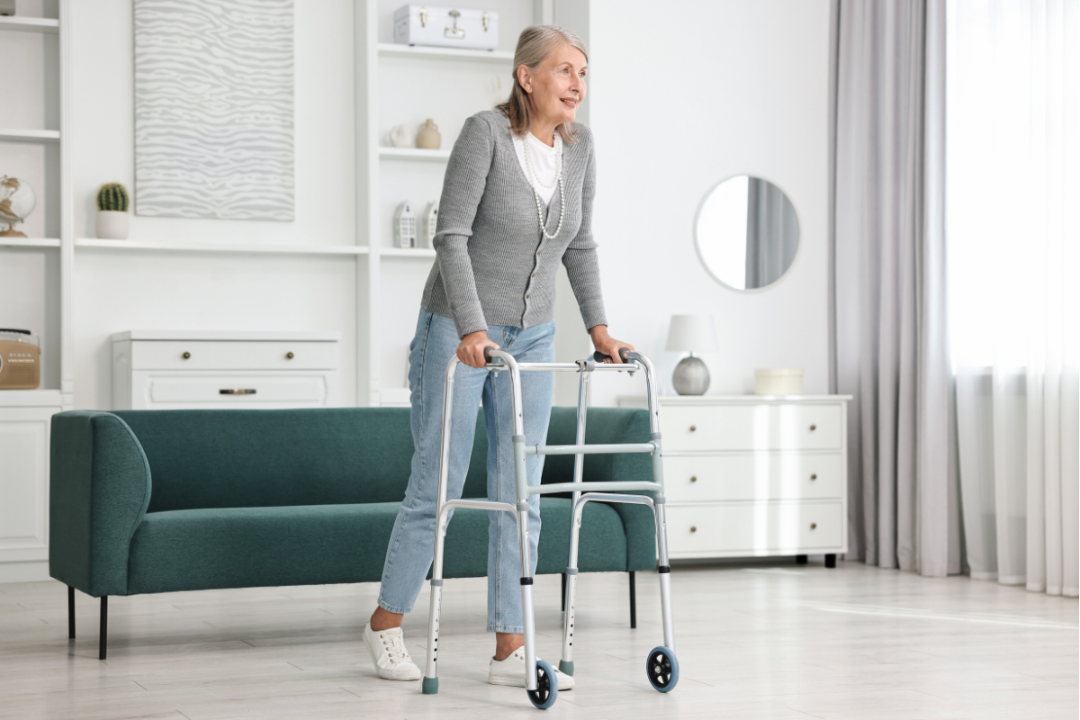 senior woman walking with walker at home